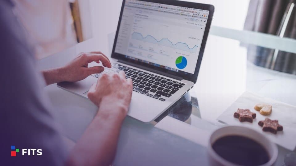 Person working on a laptop showing a business dashboard