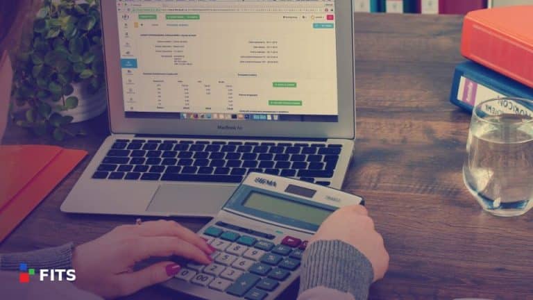 Accountant working with a calculator and laptop