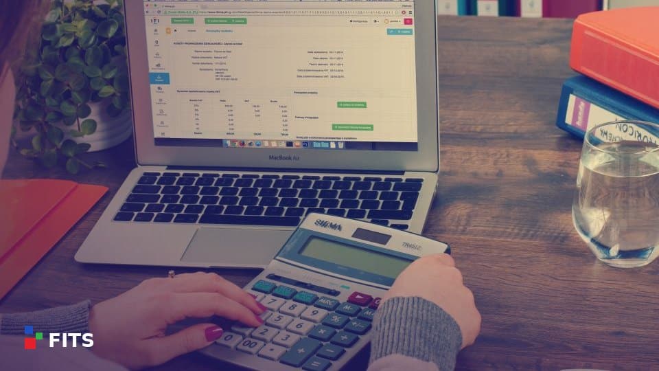 Accountant working with a calculator and laptop