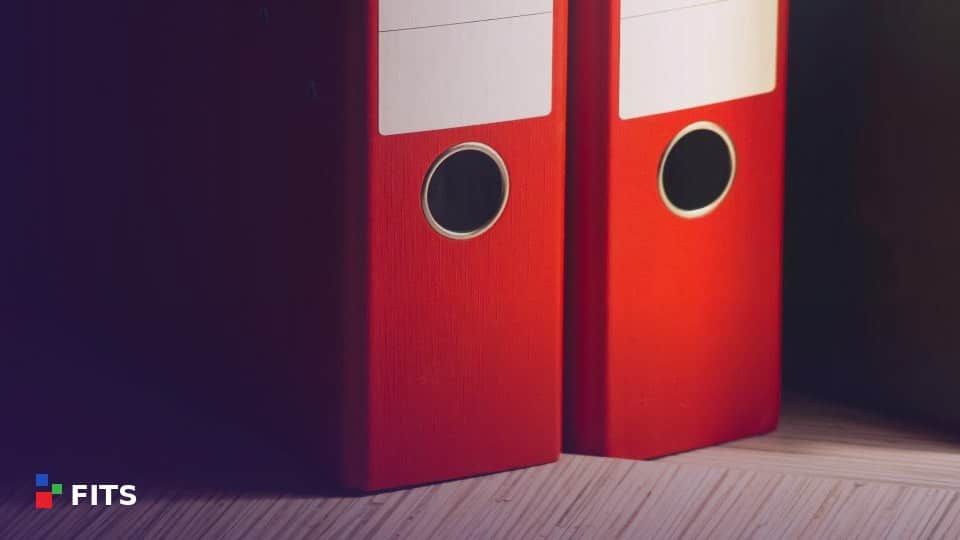 Red office binders on a shelf
