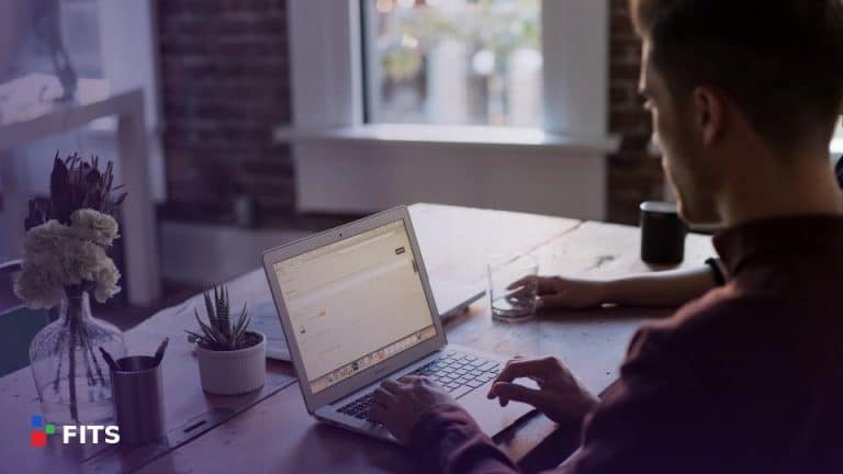 Man working on a laptop in a bright office