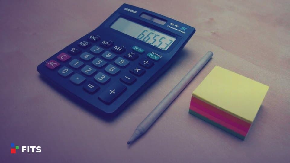 Calculator, pencil and sticky notes on a desk